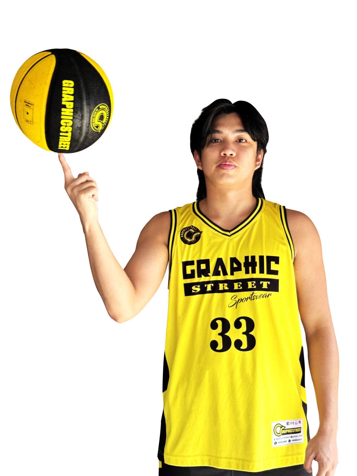 Home A person with dark hair wearing a yellow Graphicstreet basketball jersey with black trim and the number 33, skillfully balancing a yellow and black Graphicstreet basketball on their index finger. The background is white.
